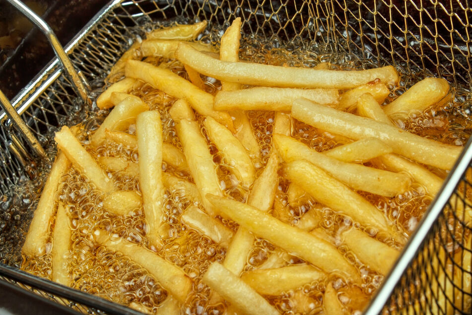 Thinly cut potato strips are most commonly fried in vegetable oil at a high temperature to create french fries.
