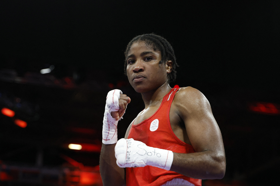 Boxer Cindy Winner Djankeu Ngamba of the Refugee Olympic Team reacts after winning her 75kg quarter-final fight against Davina Michel of France.