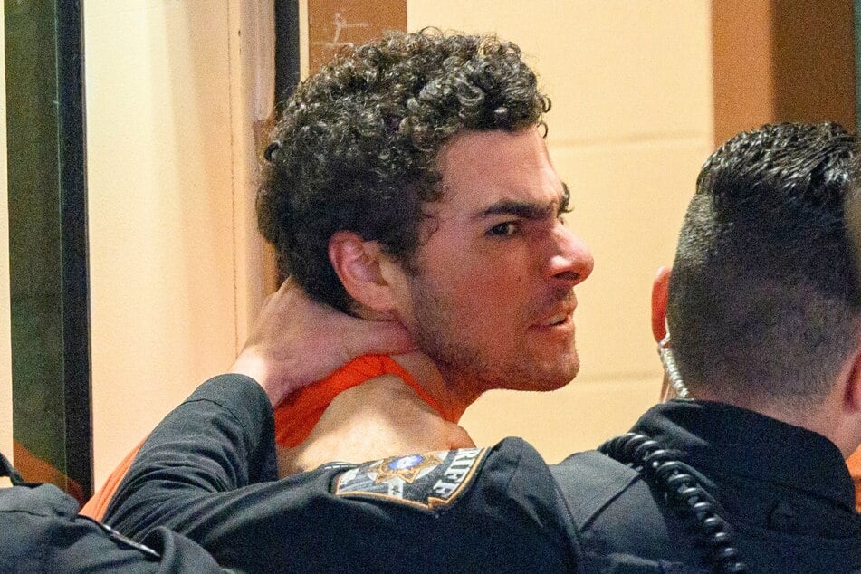 Suspected shooter Luigi Mangione is led into the Blair County Courthouse for an extradition hearing December 10, 2024 in Hollidaysburg, Pennsylvania.