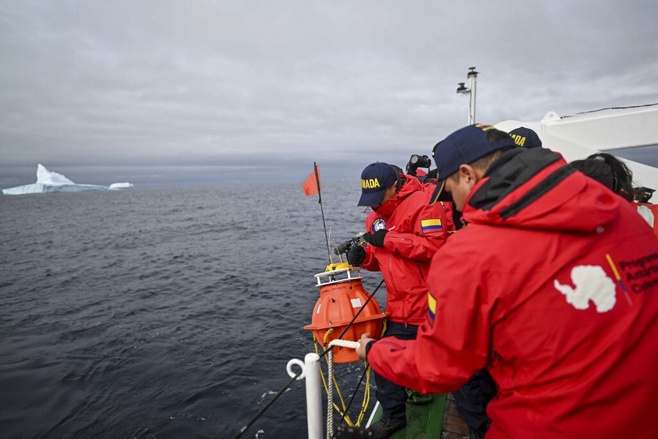 Andrea Bonilla (c.) recovers a hydrophone with members of the Colombian research vessel ARC Simon Bolivar in the south coast of Livingston Island, in the South Shetland Islands archipelago.