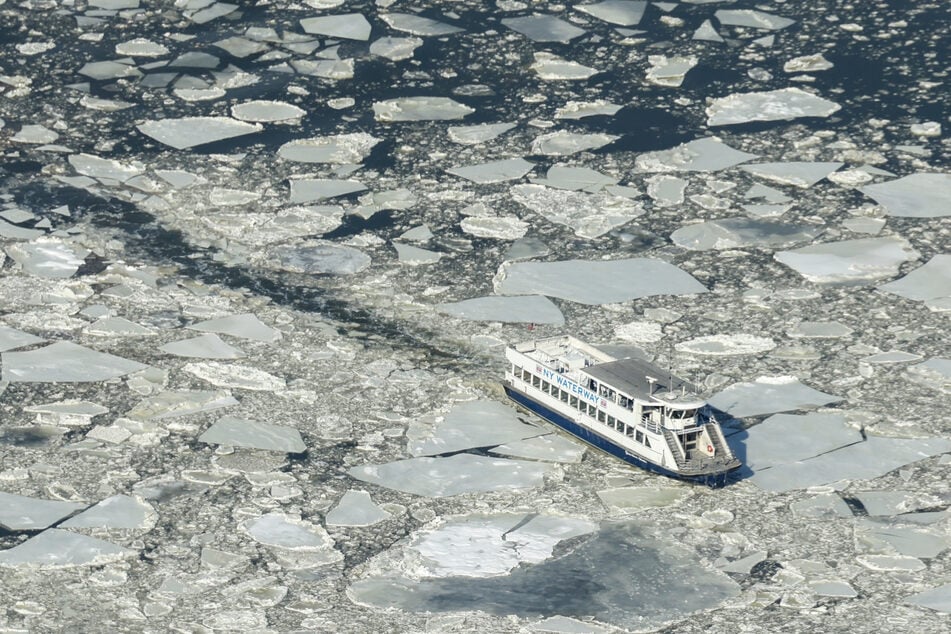 An aerial view of the Hudson River as a water taxi makes it way through the icy river during freezing temperatures, seen from the Edge observation deck in New York City on January 28, 2026.