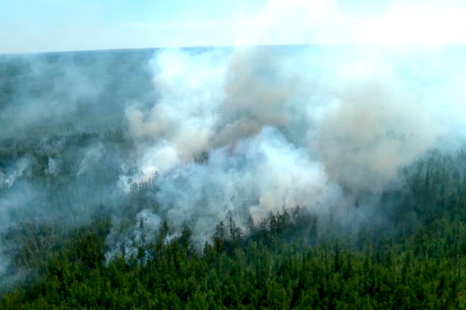 Rauchwolken steigen aus einem Wald auf. Auf mehr als 2000 Hektar eines Waldgebiets wütet nach Angaben des russischen Ministerium für Notsituationen ein Waldbrand.