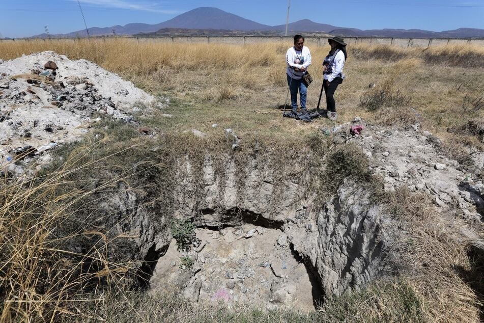 Members of the collective Guerreros Buscadores work next to a pit at the Izaguirre Ranch.