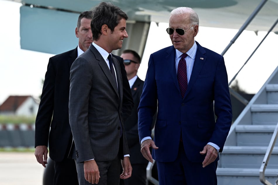 US President Joe Biden (r.) is welcomed by France's Prime Minister Gabriel Attal upon arrival at Paris Orly airport as he travels to commemorate the 80th anniversary of D-Day.