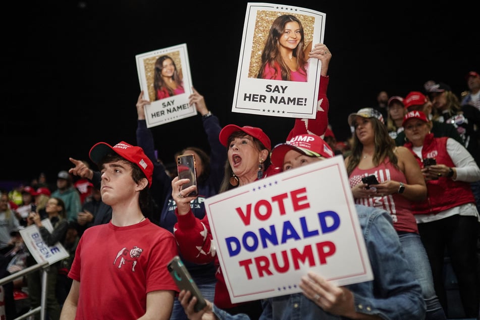 Supporters of former US President and 2024 presidential hopeful Donald Trump hold images of Laken Riley before he speaks at a "Get Out the Vote" rally in Rome, Georgia, on March 9, 2024.