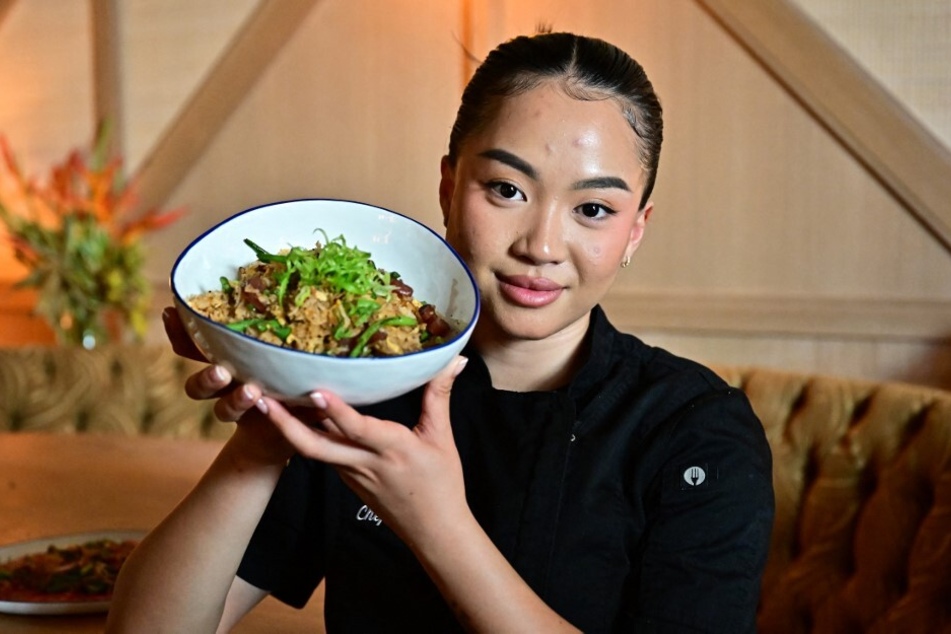 Chef Tue Nguyen presents a bowl of her Di Di fried rice at her first restaurant in Los Angeles, California.