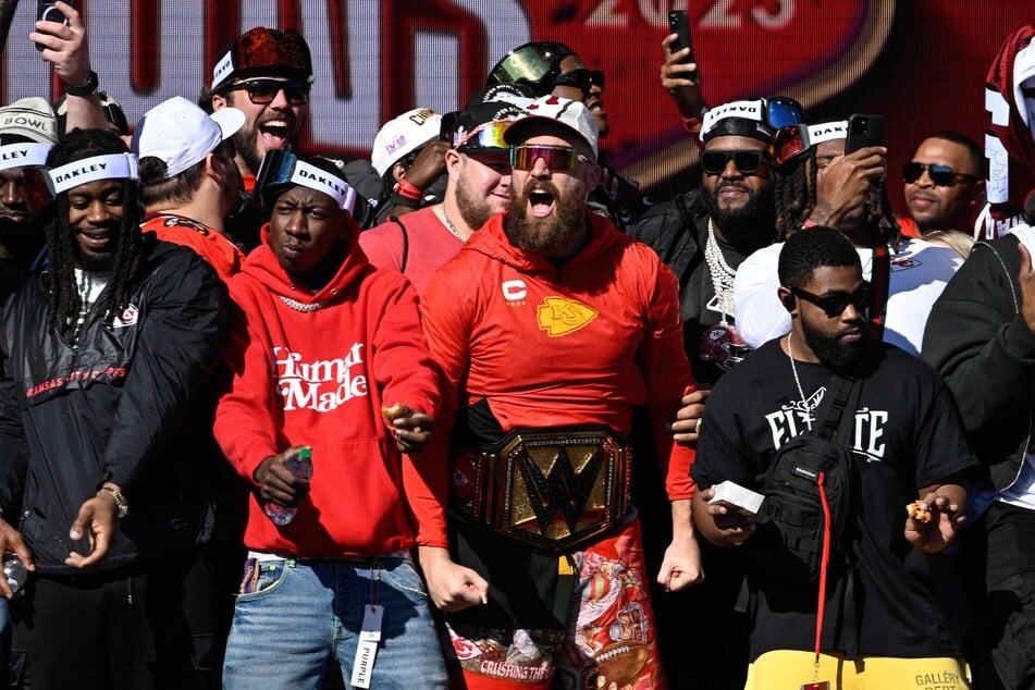 Kansas City Chiefs tight end Travis Kelce (c.) celebrated onstage with teammates during the Chiefs' Super Bowl LVIII victory parade on Wednesday, just before a mass shooting occured.
