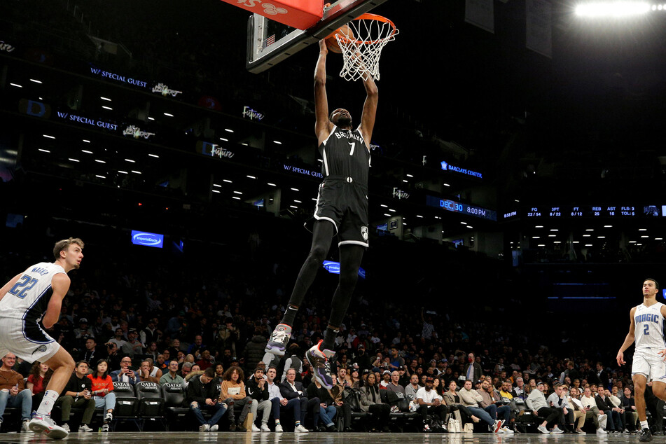 Brooklyn Nets forward Kevin Durant dunks against Orlando Magic forward Franz Wagner and forward Caleb Houstan during the third quarter at Barclays Center.