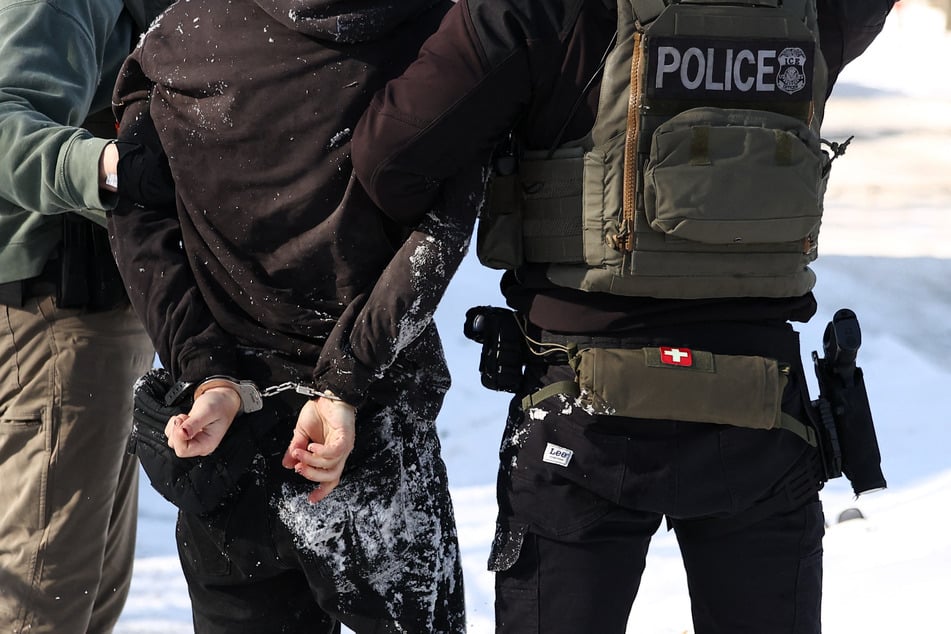 Federal agents detain a protester in Minneapolis, Minnesota on Tuesday.