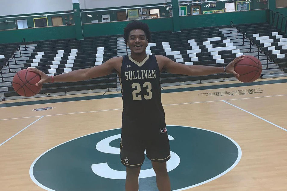 Darius Lee posing on the basketball court during team picture day.