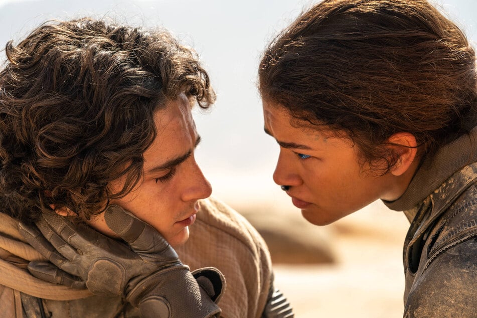 Timothée Chalamet (l.) and Zendaya return as Paul Atreides and Chani, respectively, as they continue to fight for freedom in Dune: Part Two.