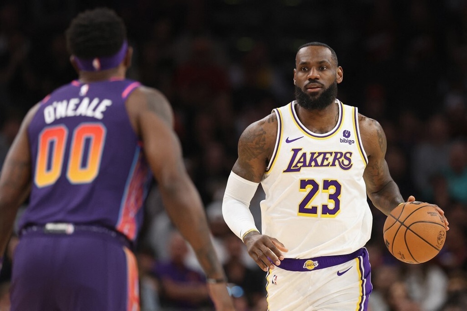 The Phoenix Suns are reportedly considering Bronny James as a potential pick in this year's NBA Draft to possibly lure his father, LeBron James (r.), from the Lakers.