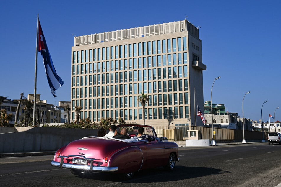 A car drives past the US Embassy in Havana, on Tuesday.