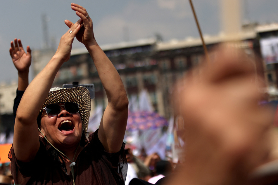 People cheer as Mexican President Andres Manuel Lopez Obrador delivers his final State of the Union address at Zocalo Square.