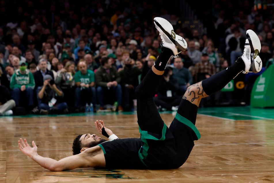 Boston Celtics forward Jayson Tatum hits the floor after his team fell to the Phoenix Suns during Friday night's game in Boston.