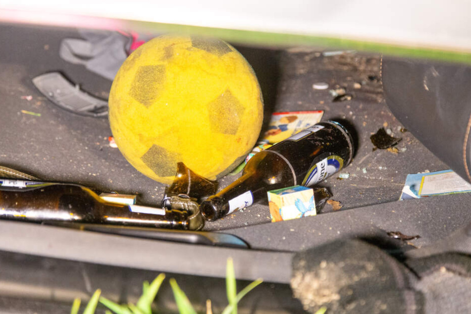 Neben dem Kinderspielzeug lagen überall leere Bierflaschen in dem Auto umher.