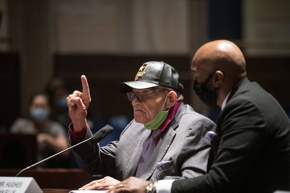 Hughes Van Ellis, alongside his attorney, Damario Solomon-Simmons, delivers testimony during a House Judiciary Subcommittee on the Constitution, Civil Rights, and Civil Liberties hearing on May 19, 2021.