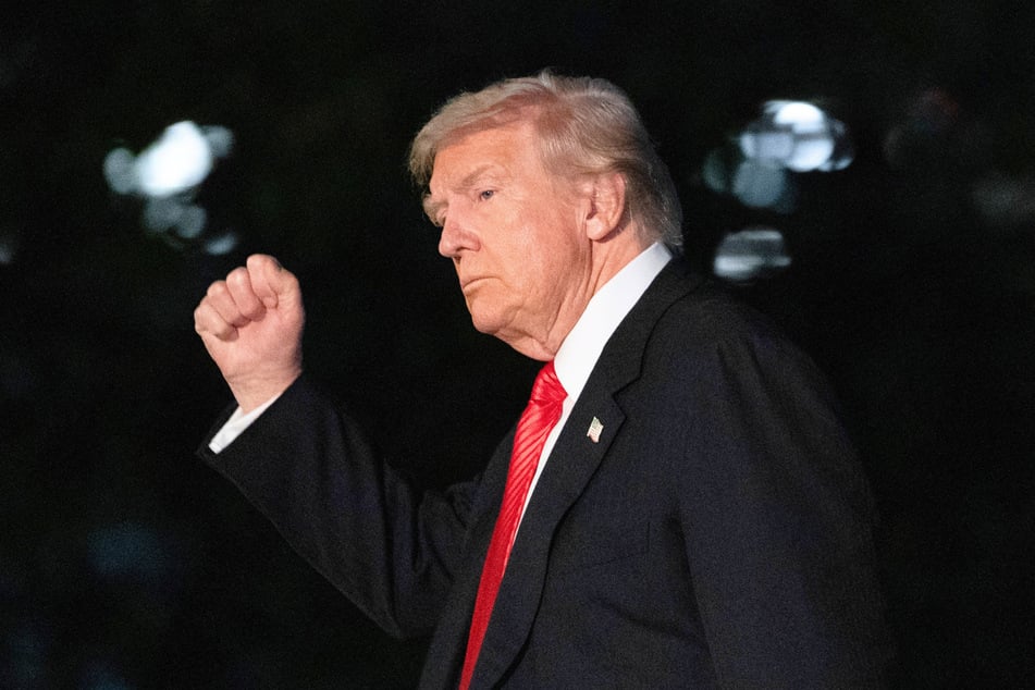 President Donald Trump gestures as he walks on the South Lawn upon arrival at the White House in Washington DC on November 2, 2025.