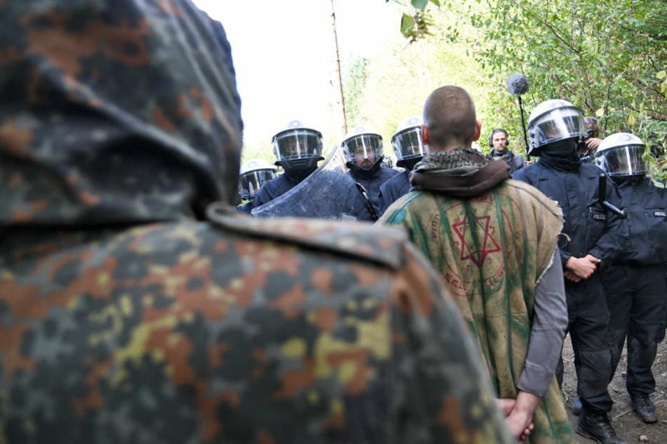 Aktivisten stehen Polizisten am Freitag im Hambacher Forst gegenüber. Am Samstag gab es eine große Demo am Wald.
