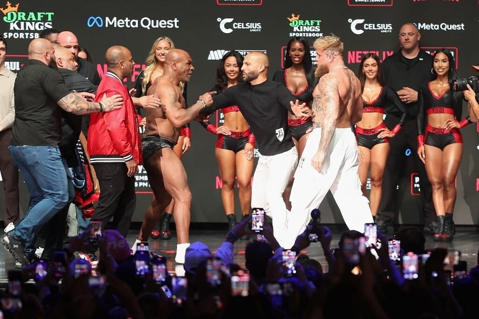 Mike Tyson and Jake Paul are separated as they face off during their ceremonial weigh-in at The Pavilion at Toyota Music Factory on November 14, 2024.