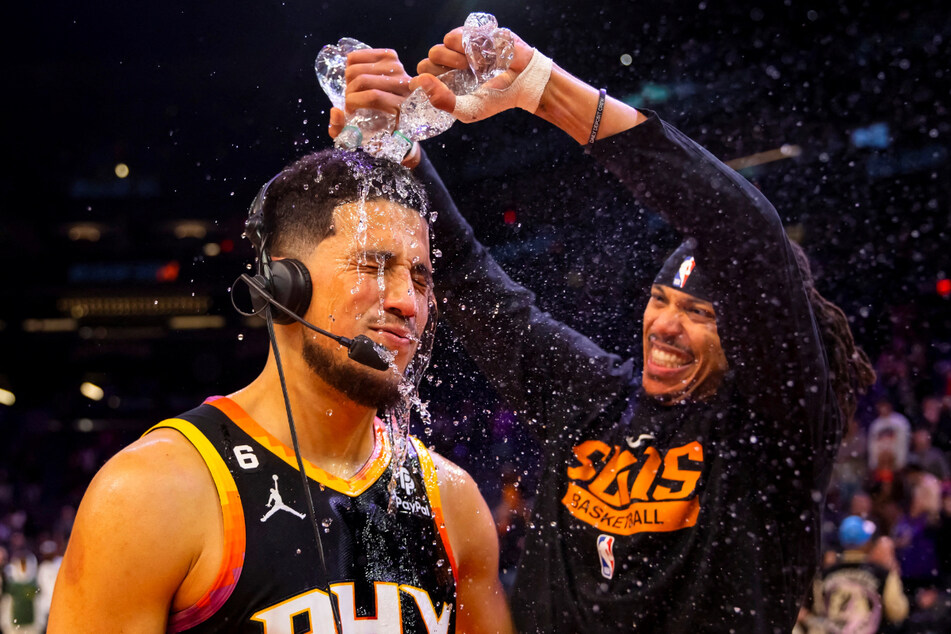 Phoenix Suns guard Devin Booker had water dumped on him by teammate Damion Lee after reaching a season high and defeating the New Orleans Pelicans on Saturday.