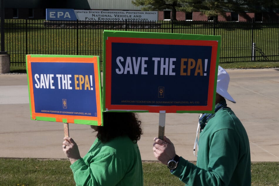 Demonstrators march during a "Hands off the EPA" rally outside the Environmental Protection Agency offices in Ann Arbor, Michigan, on Earth Day, April 22, 2025.