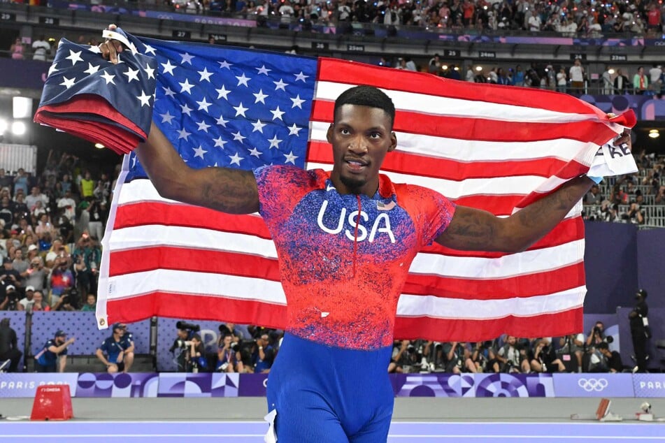 US' Fred Kerley celebrates after winning bronze in the men's 100m final of the athletics event at the Paris 2024 Olympic Games at Stade de France in Saint-Denis, north of Paris, on August 4, 2024.