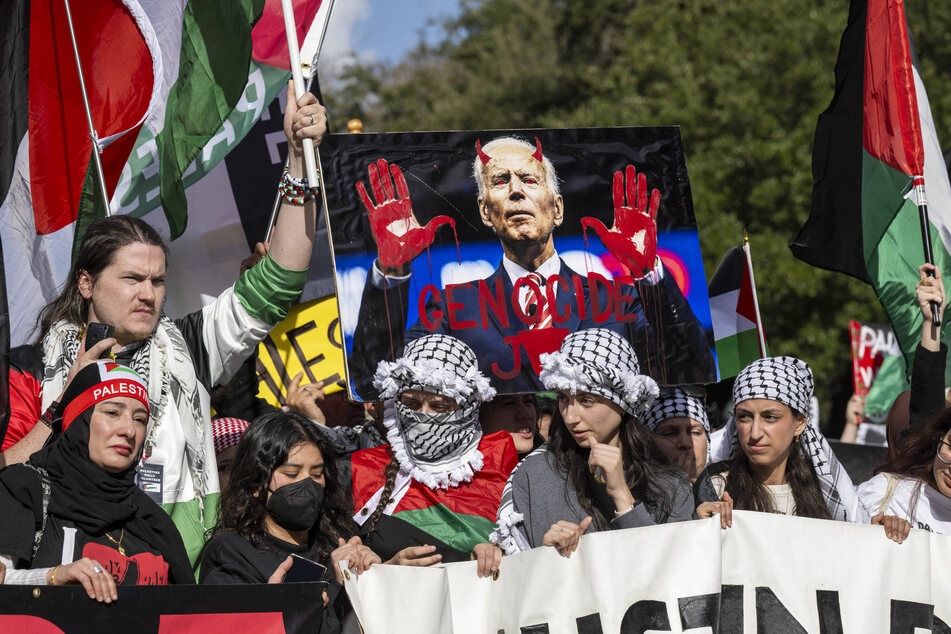 Supporters of Palestinian freedom raise a sign reading "Genocide Joe" during a rally in Austin, Texas.