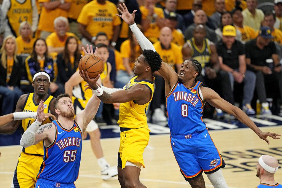 Pacers guard Bennedict Mathurin shoots the ball against Oklahoma City Thunder center Isaiah Hartenstein and forward Jalen Williams during the fourth quarter in Game Three of the 2025 NBA Finals.