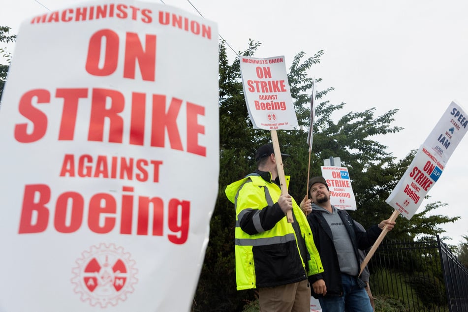 Boeing factory workers gather on a picket line during the first day of a strike near the entrance of a production facility in Renton, Washington.