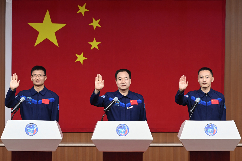 Astronauts Jing Haipeng, Zhu Yangzhu, and Gui Haichao attend a press conference before the Shenzhou-16 spaceflight mission to China's space station.