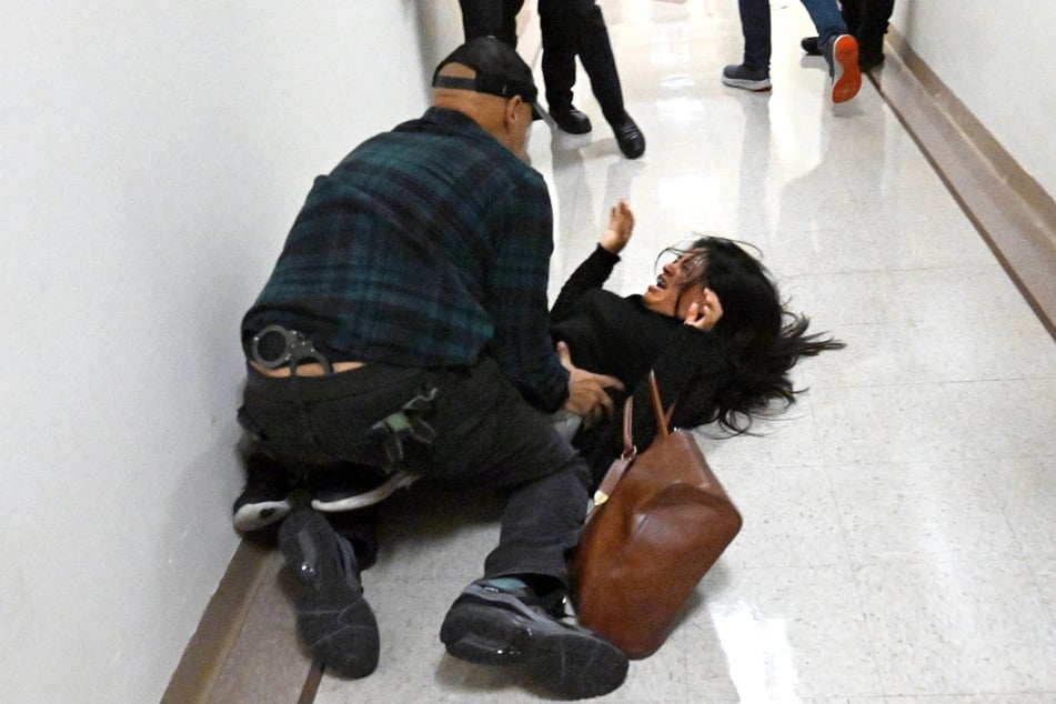 An ICE agent was relieved of duty on Friday over a video showing him slamming the wife of a detained migrant to the ground in New York City.