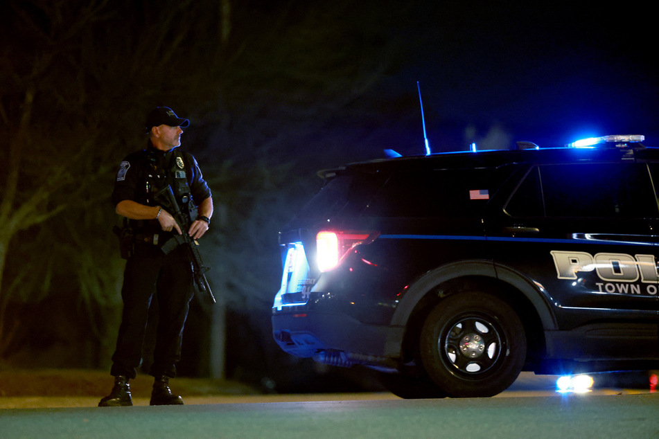 Police man a roadblock leading to the area where Robert Card, the suspect in two mass killings, was found dead on October 27, 2023 in Lisbon, Maine.