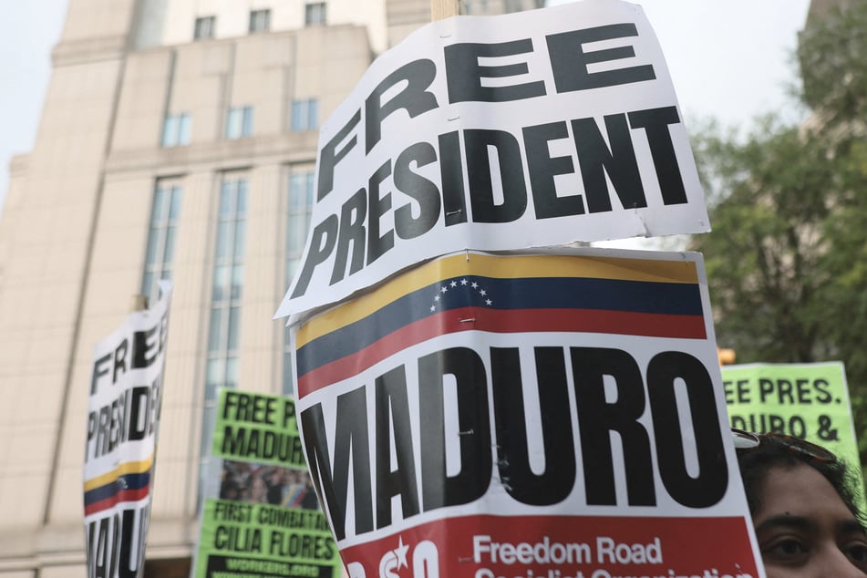 Protesters with signs reading "Free President Maduro" gathered outside the Manhattan courthouse waving Venezuelan flags on Wednesday.