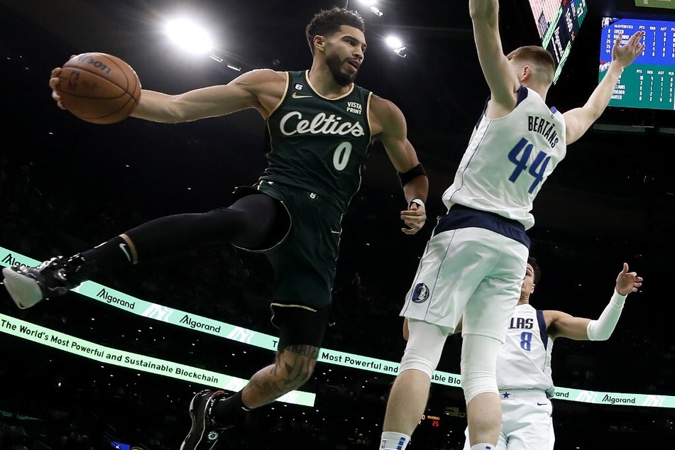 Jayson Tatum of the Boston Celtics looks to pass around Davis Bertans of the Dallas Mavericks during the second quarter at TD Garden.