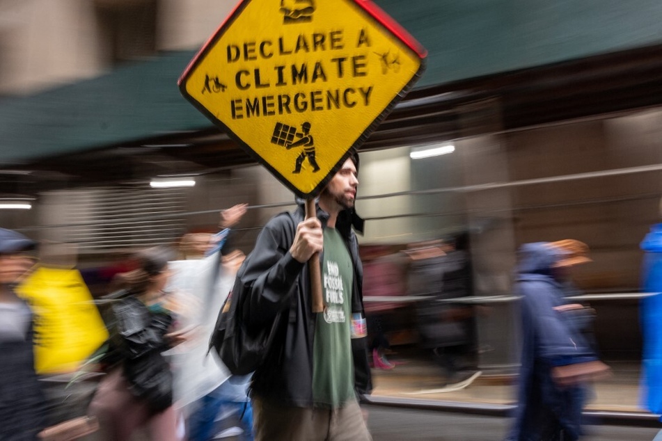 Protesters hold a demonstration in New York City's Financial District to demand an end to fossil fuel funding by Wall Street and the US government on September 18, 2023.