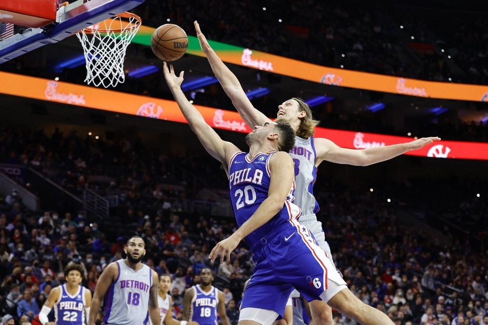Kelly Olynyk of the Detroit Pistons guards Georges Niang of the Philadelphia 76ers at Wells Fargo Center.