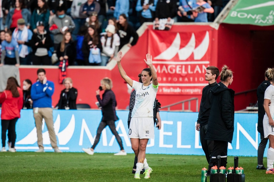 Carli Lloyd waves to the fans after her last professional match this past Sunday.