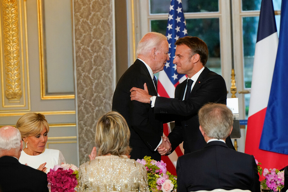 French President Emmanuel Macron shakes hands with US President Joe Biden at a state dinner at the Elysee Palace in Paris.
