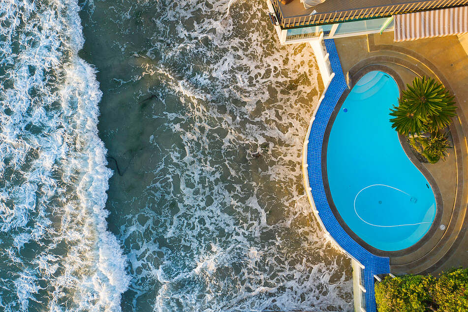 The ocean is getting cuddly with the sea wall below this San Diego oceanfront home. The area will see rising sea levels of at least six feet by the end of the century.