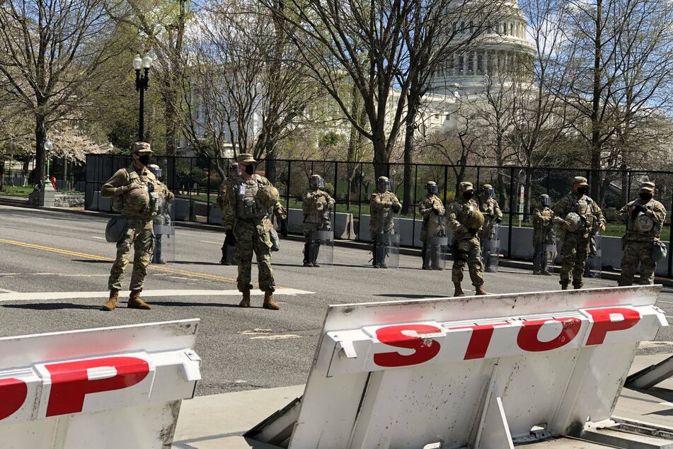 National Guard members stand guard in front of the U.S. Capitol building in Washington DC after the attack.