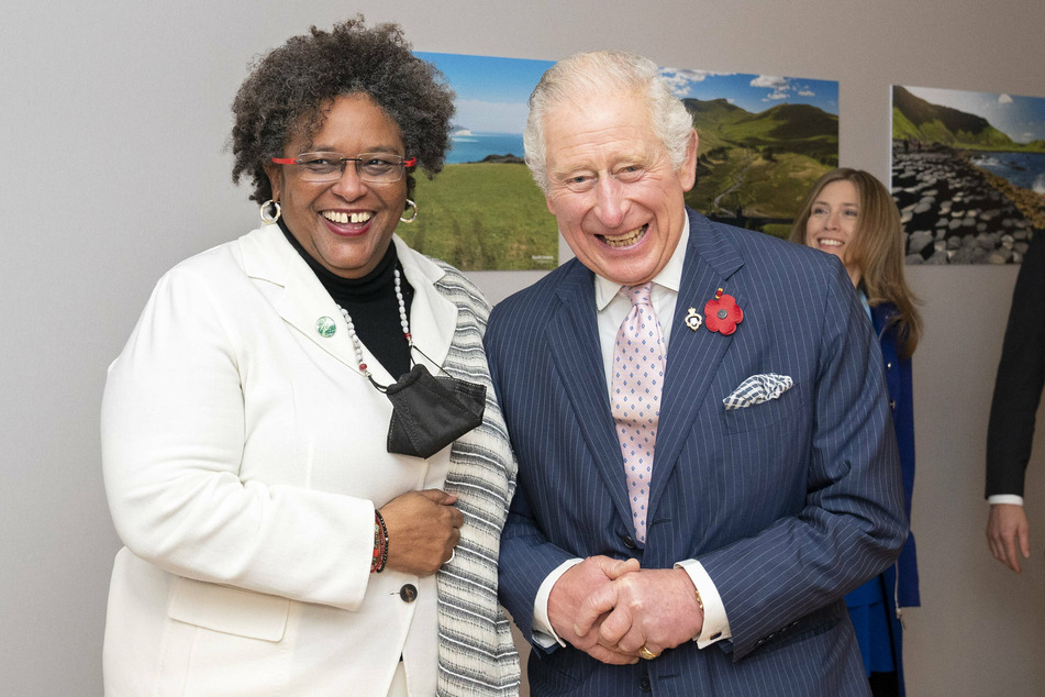 Prime Minister Mia Mottley (l.) greets the Prince of Wales before their bilateral meeting at the COP26 climate summit.