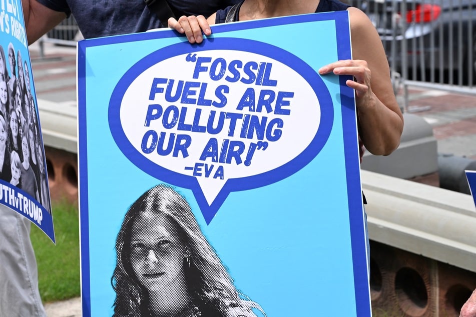 A protester holds a sign with a quote from Eva Lighthiser, the lead plaintiff in Lighthiser v. Trump, in a demonstration at the US Capitol on July 16, 2025.
