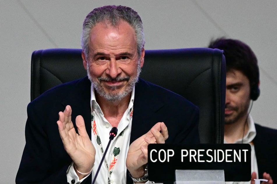 COP30 President Andre Correa do Lago applauds during the plenary session at the UN climate conference in Belem, Brazil, on November 22, 2025.