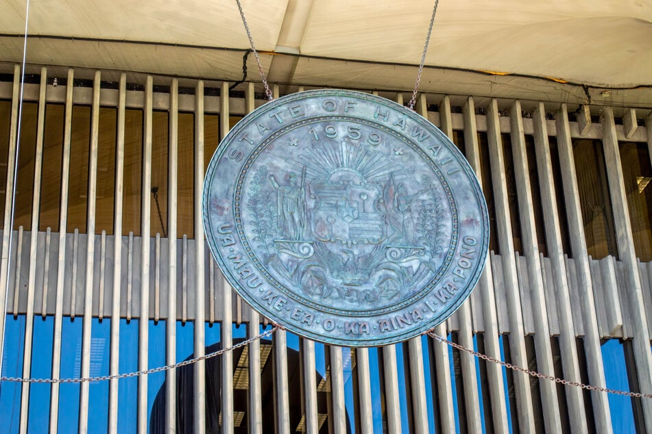 The seal of the State of Hawaii hangs over the front entrance of the Capitol building in Honolulu.