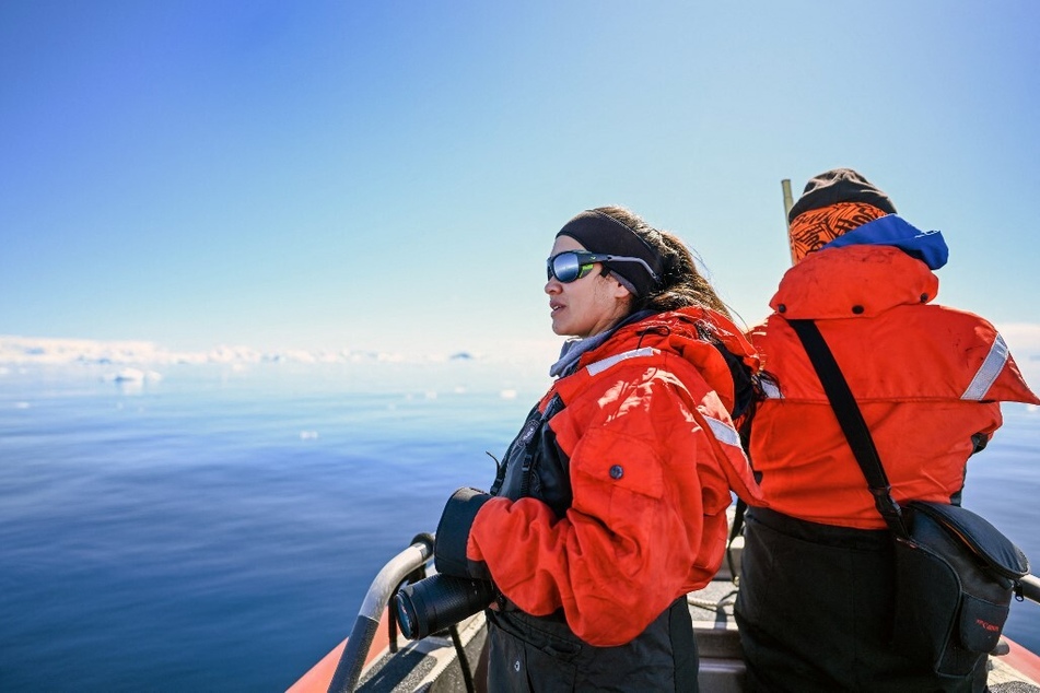 Colombian researcher Andrea Bonilla Garzon (l.) and Colombian scientist Diego Mojica of Malpelo foundation work during whale watching at the Gerlache Strait, which separates the Palmer Archipelago from the Antarctic Peninsula.
