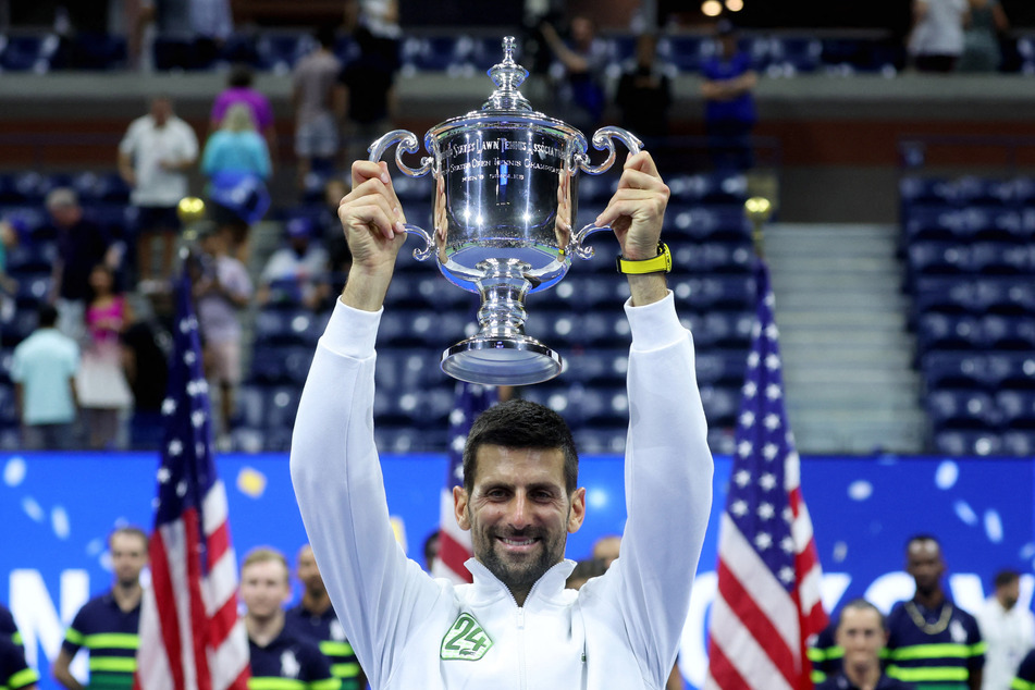 Serbia's Novak Djokovic celebrates with the trophy after winning the 2023 US Open.
