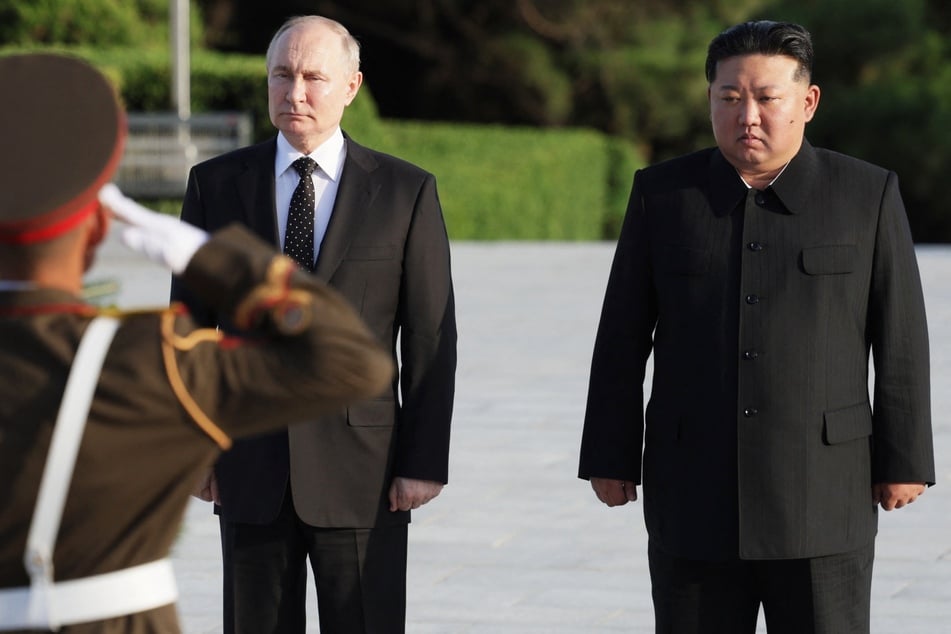 Russia's President Vladimir Putin (l.) has reportedly sent a letter to North Korean leader Kim Jong Un (r.) praising Pyongyang's soldiers fighting in Ukraine.