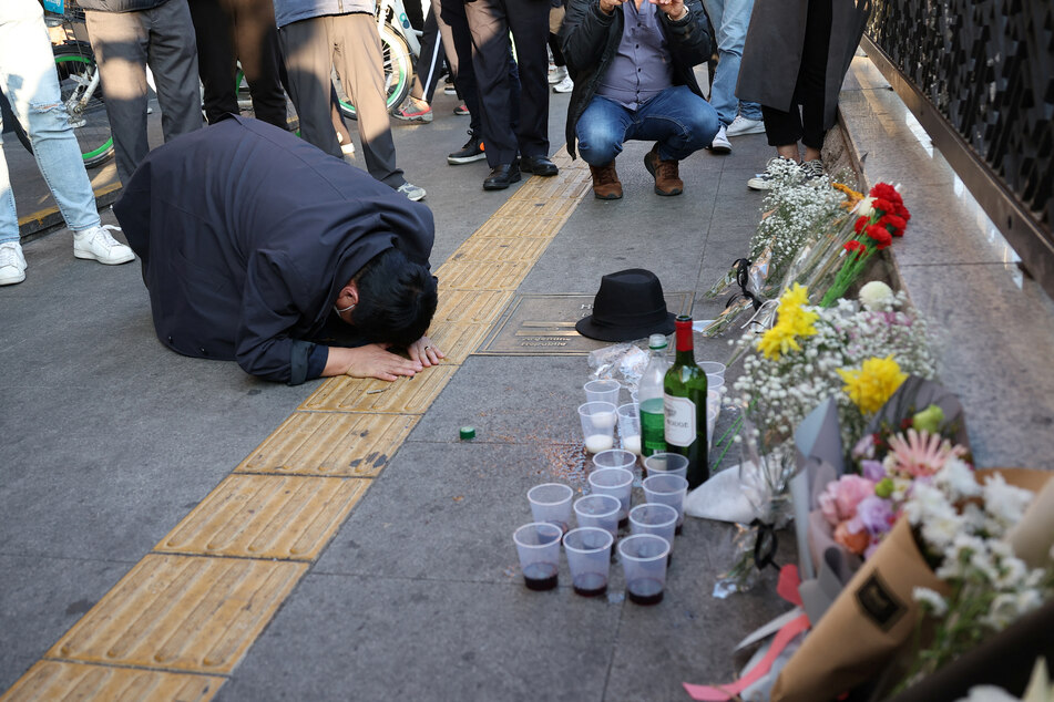 A man bows after paying tribute near the scene of the stampede during Halloween festivities in Seoul, South Korea.