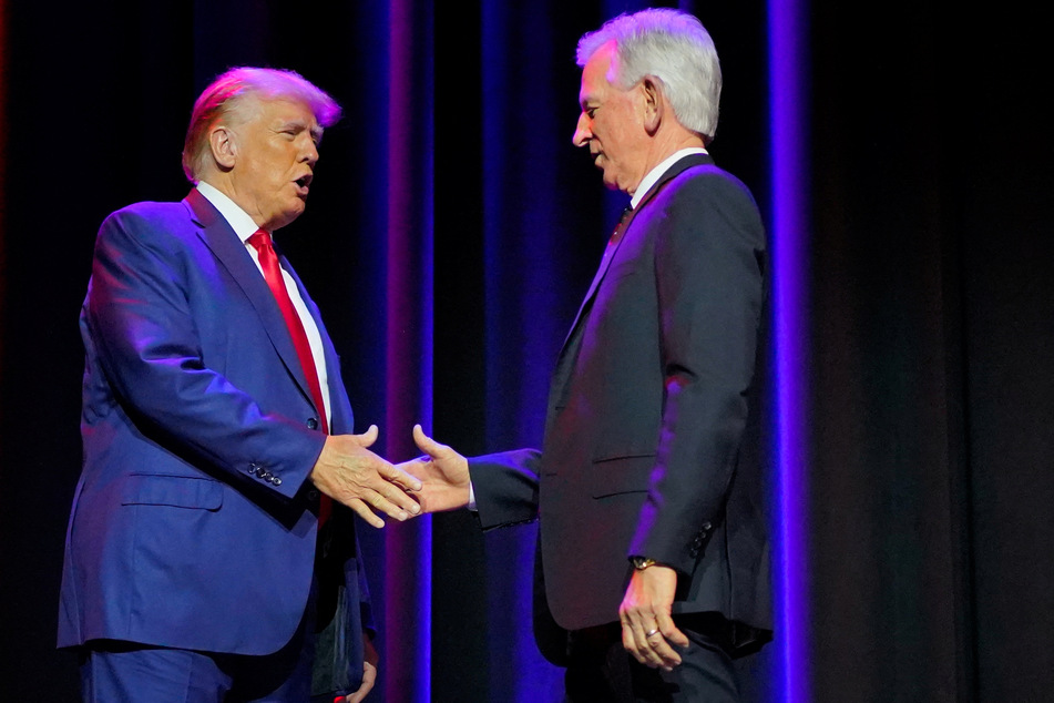 Trump shakes hands with Alabama Senator Tommy Tuberville, an ardent supporter of the former president.